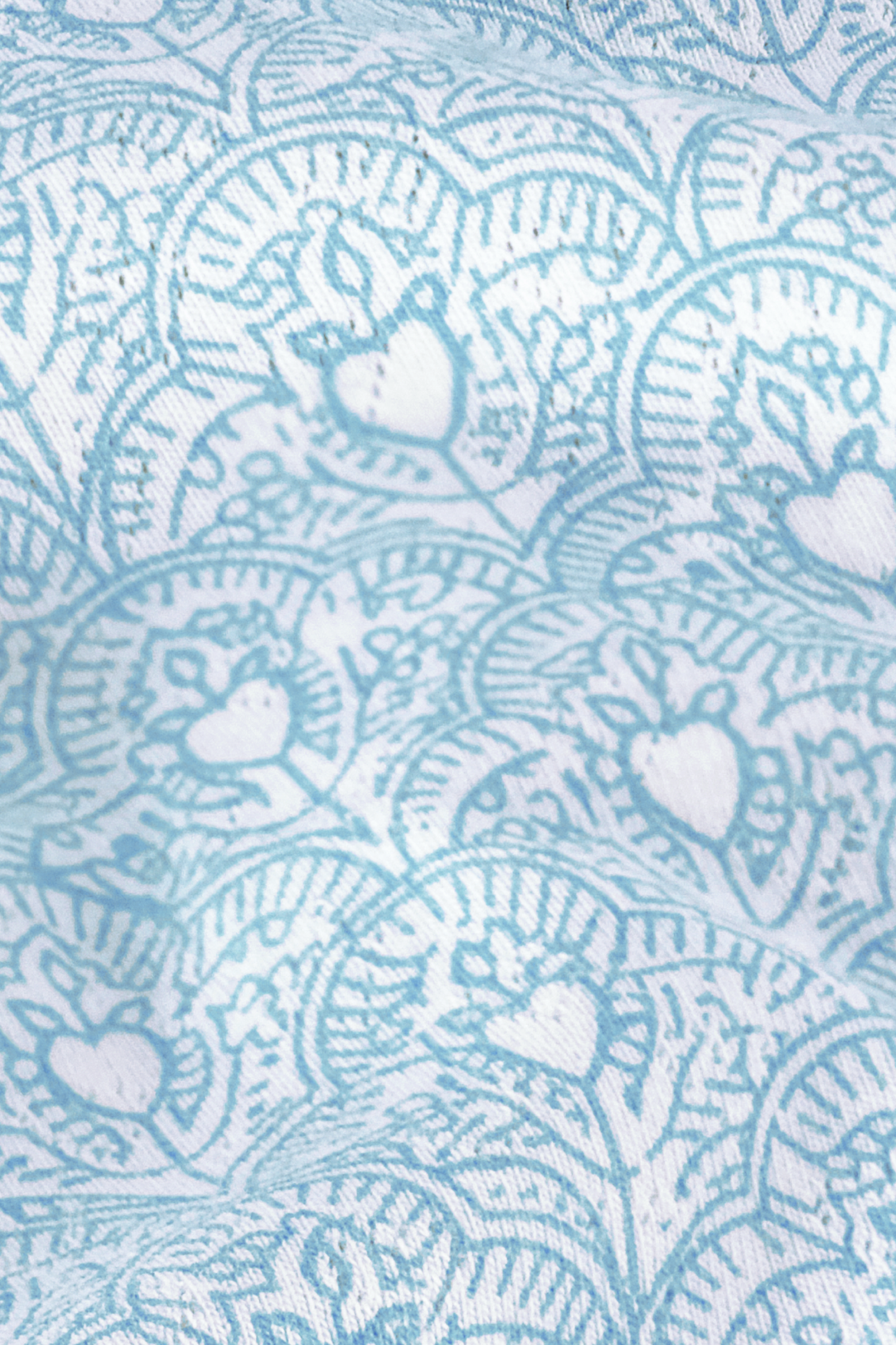 Light blue and white fabric featuring stylized turtles and circular wave patterns—ideal for the Jemina Hearts Pointelle Claire Cardigan. The subtle wrinkled texture adds depth and shadow to the design.