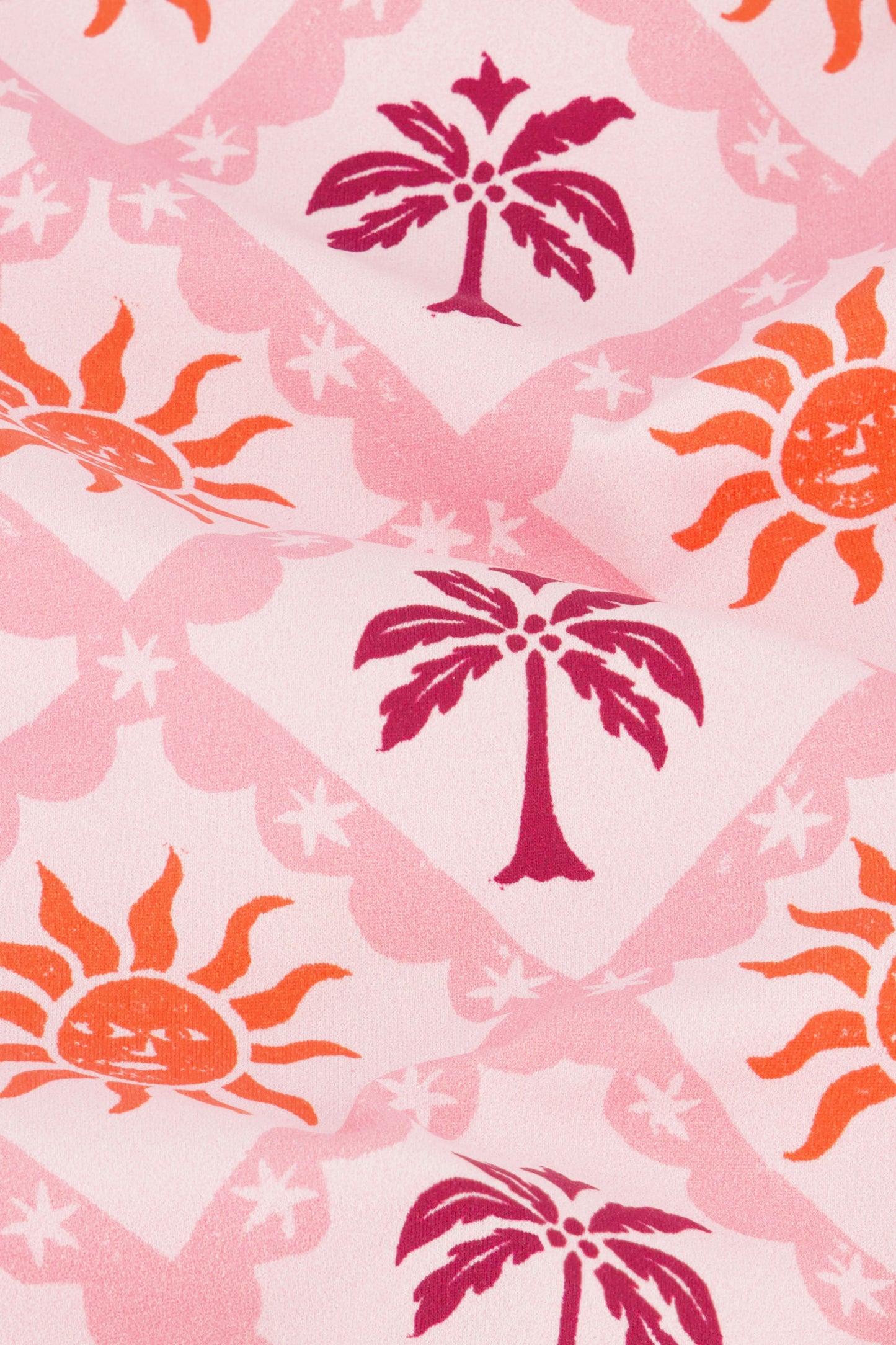 Featuring pink fabric with dark pink palm trees in diamonds and orange suns with faces, the Sunny Days Shelly Bikini Top by Roller Rabbit offers a vibrant, tropical look—perfect for those who love pink and orange swimwear.