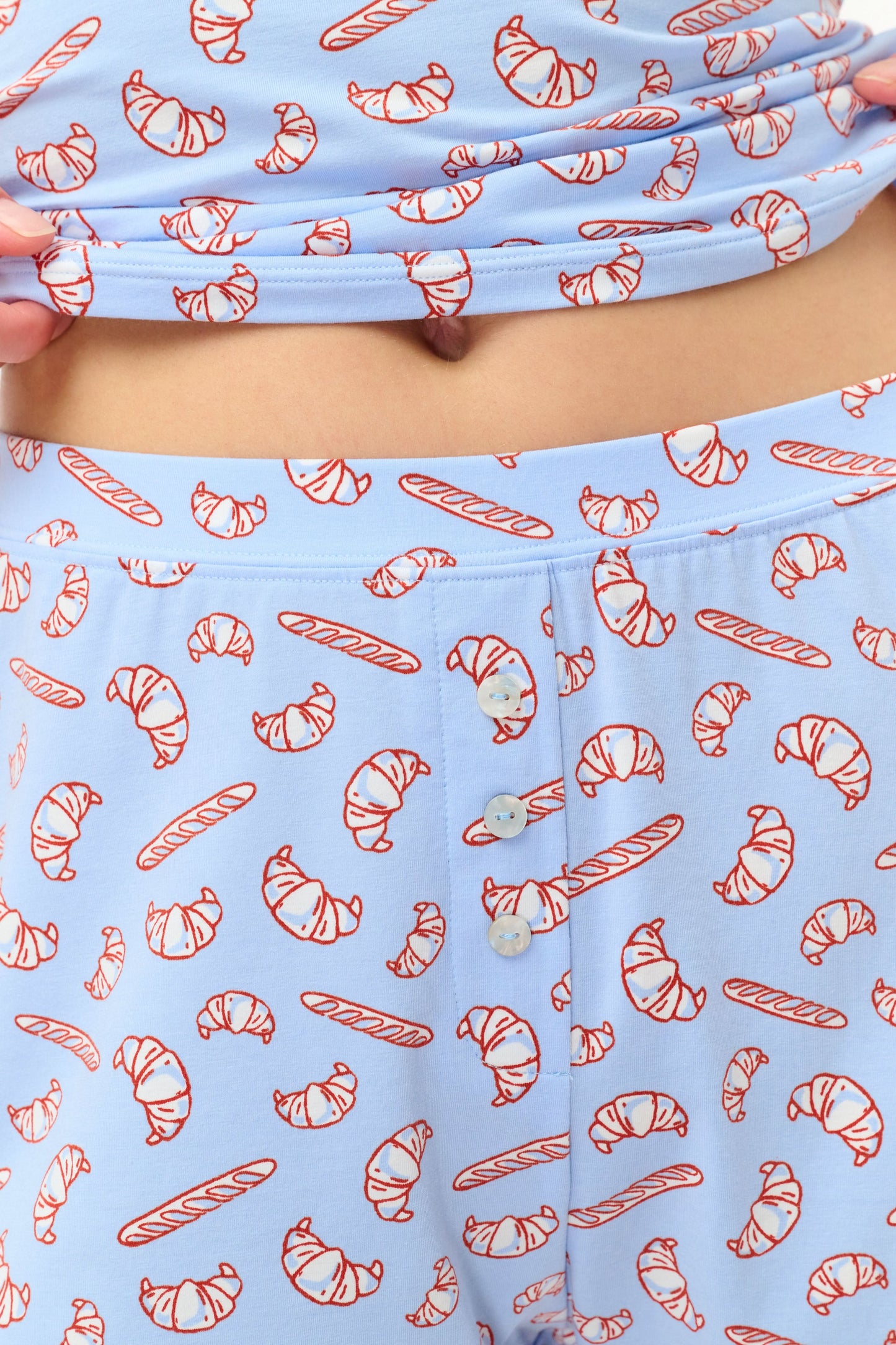 Wearing Roller Rabbit’s Breakfast In Bread Sullivan Shortie pajamas, a person stands against a white background.