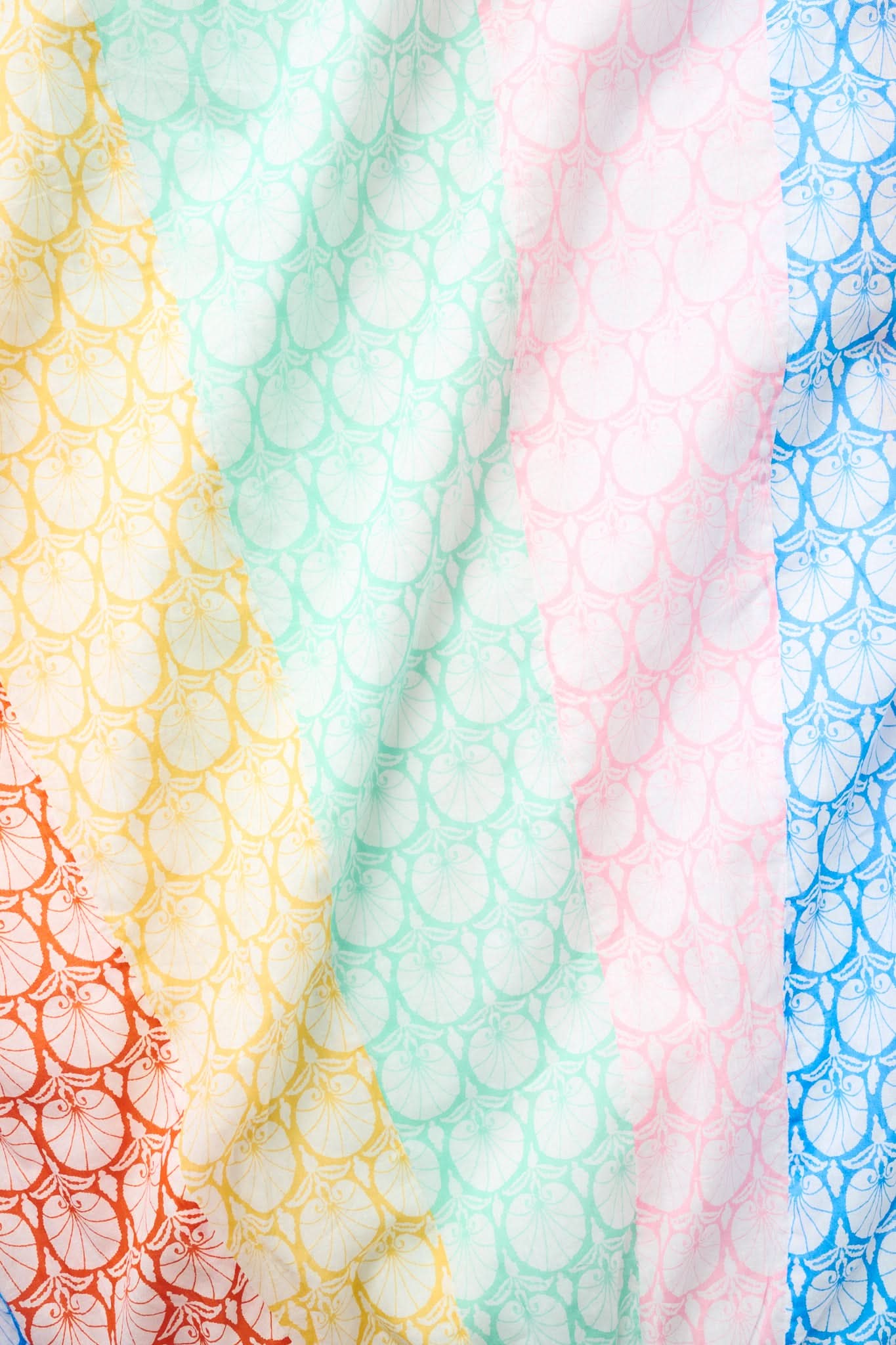 The Fan Geo Courtney Dress by Roller Rabbit features soft cotton voile with yellow, orange, green, pink, and blue diagonal stripes accented by delicate floral and fan patterns—perfect for a colorful and breezy look.