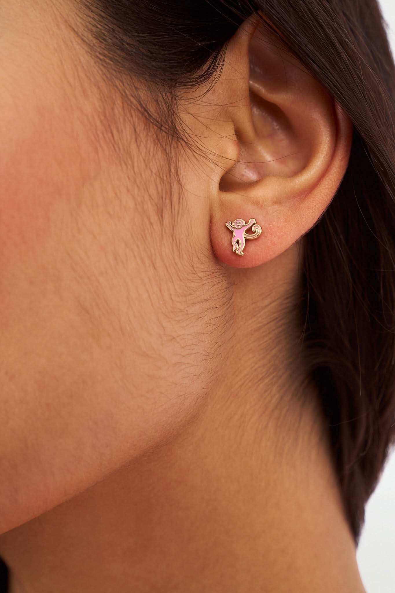 The Icon Party Earring Pack by Roller Rabbit features four pairs of gold and pink icon earrings—whales, hearts, elephants, and unicorns—arranged in two rows on a white background for a fun, playful style.