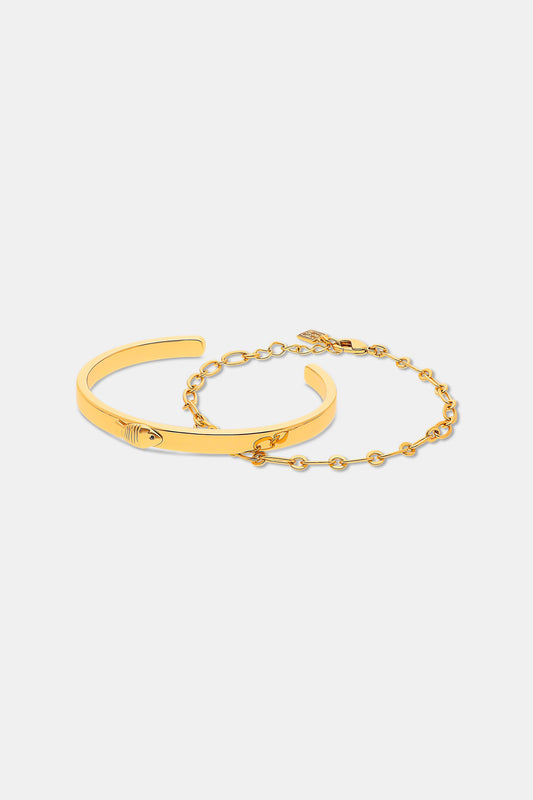 The Roller Rabbit Citra Fish Bracelet Set features a solid open cuff with an engraved detail and a delicate round-link chain with clasp, both shown on white. This elegant gold set is versatile for any occasion.