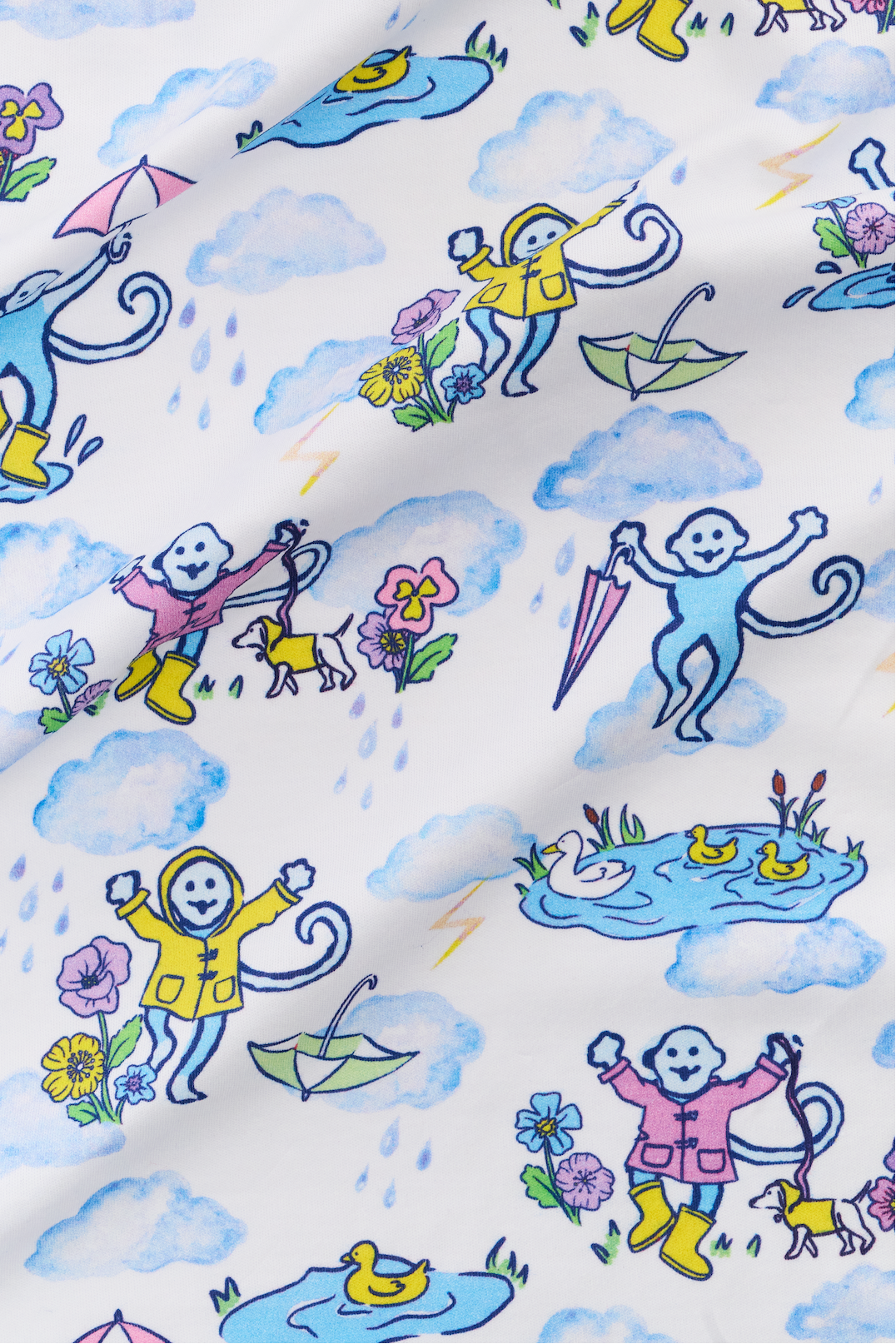 The April Showers Polo Pajamas by Roller Rabbit is a short-sleeved, button-up Pima cotton set with matching shorts, featuring a colorful aquatic animal print in blue, yellow, and purple on white.