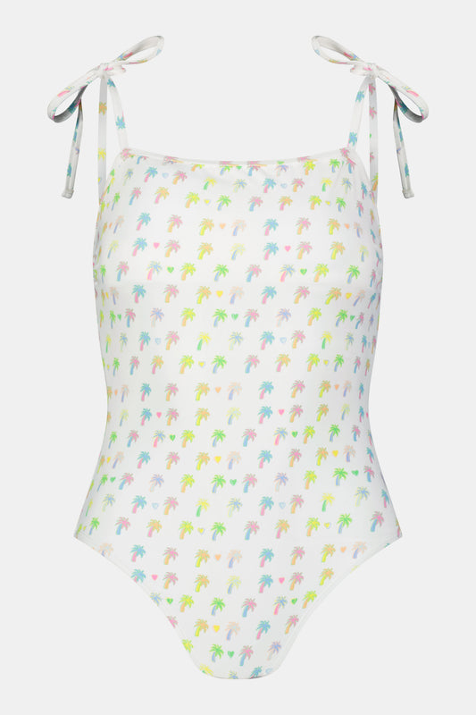 The Roller Rabbit Palm Dreams Cove One Piece is a white swimsuit with vibrant palm tree patterns and adjustable tie shoulders in matching fabric.