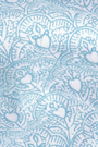 Light blue and white fabric featuring stylized turtles and circular wave patterns—ideal for the Jemina Hearts Pointelle Claire Cardigan. The subtle wrinkled texture adds depth and shadow to the design.