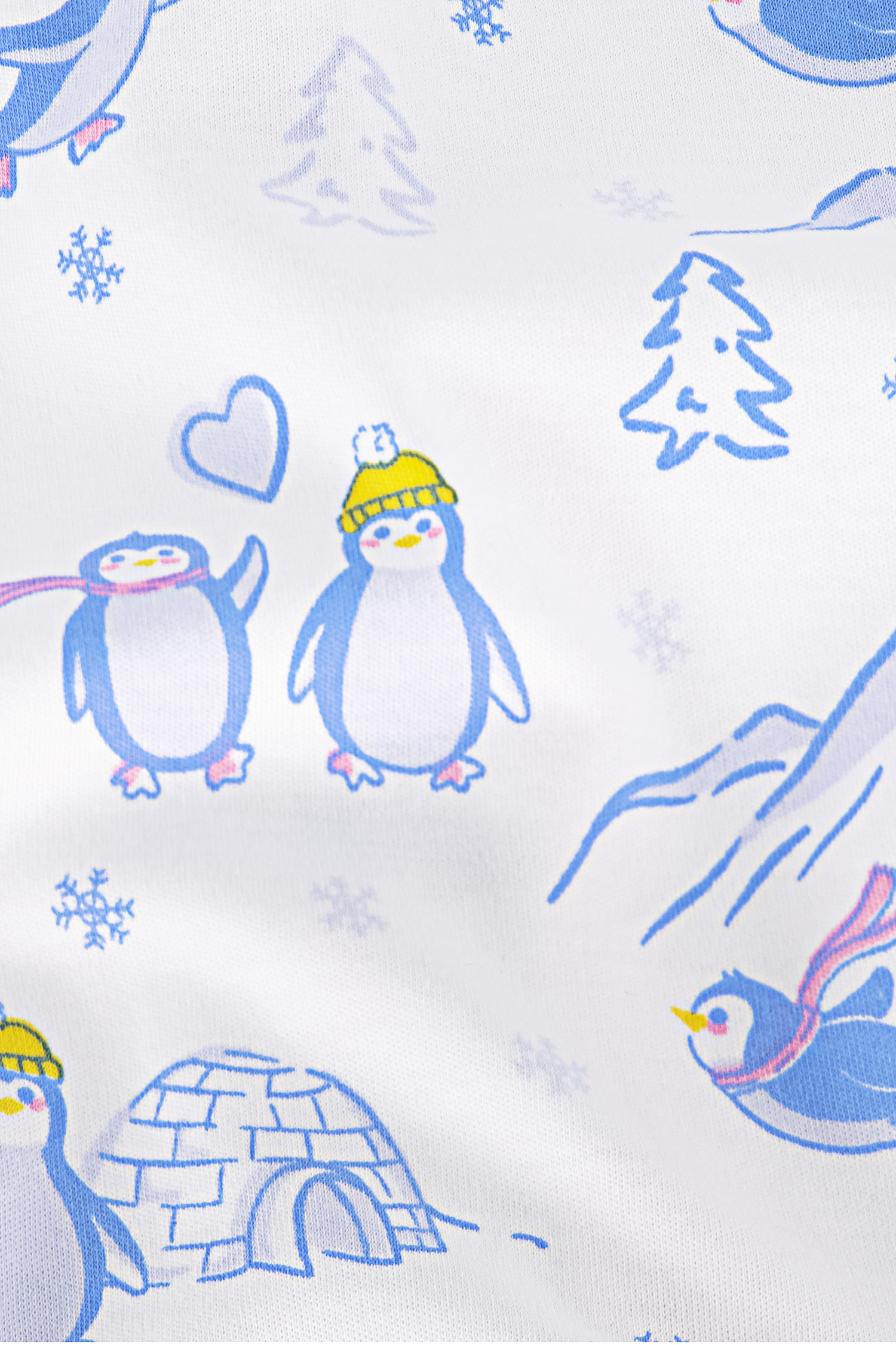 The Penguin Party Long Sleeve Polo Pajamas feature cozy Pima cotton with cartoon penguins in yellow hats and scarves, snowflakes, pine trees, an igloo, and hearts on a blue and yellow print over a white background.