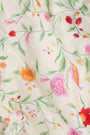 A woman wears the Roller Rabbit Baroque Floral Saylor Set—light cotton loungewear with a sleeveless ruffled top and loose shorts—standing with one hand in her pocket against a plain background.