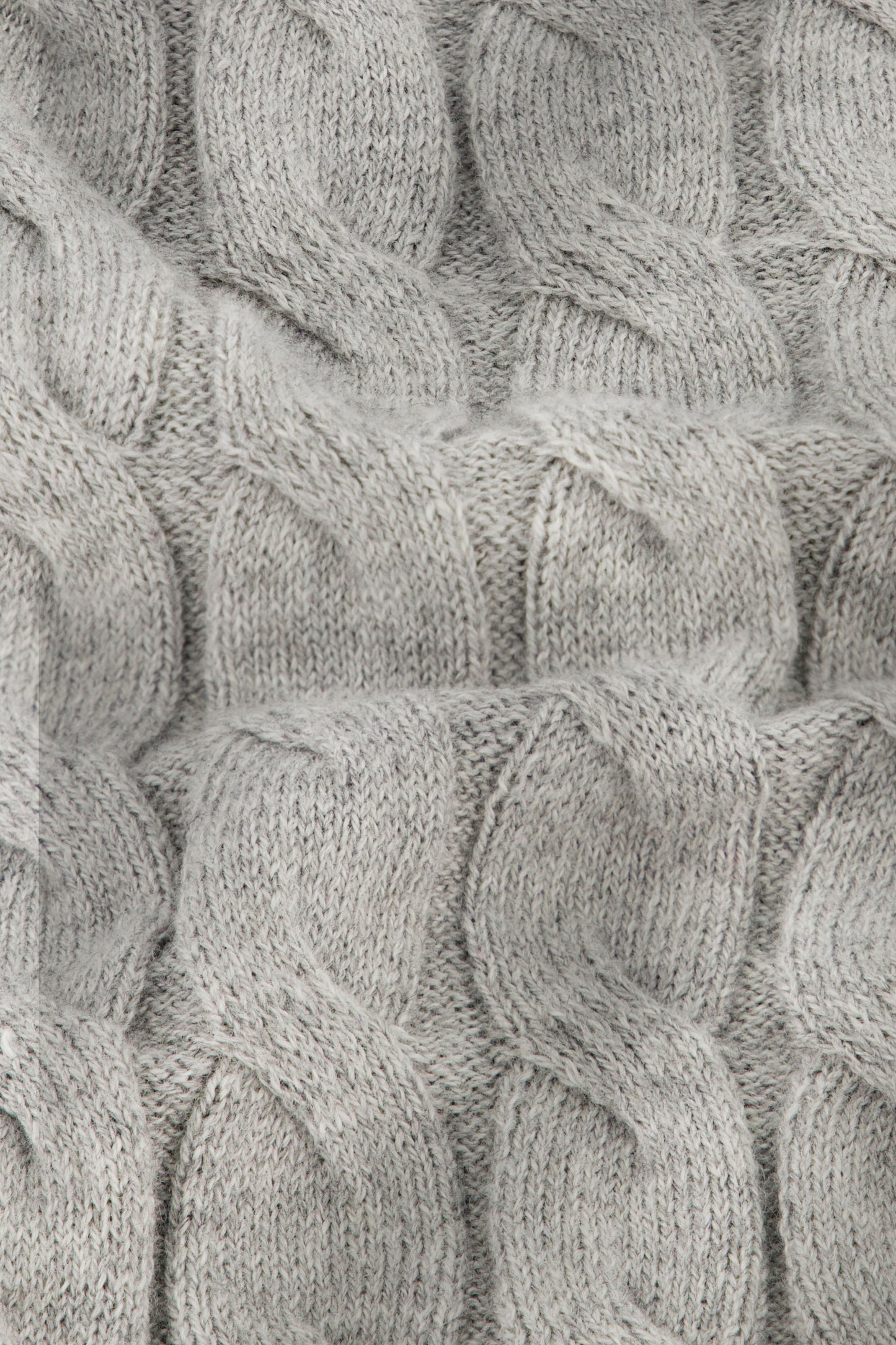 Close-up of the Mini Cables Olivia Pant by Roller Rabbit, featuring soft light gray cotton-cashmere knit with a textured pattern of raised, twisted stitches—ideal for cozy loungewear.