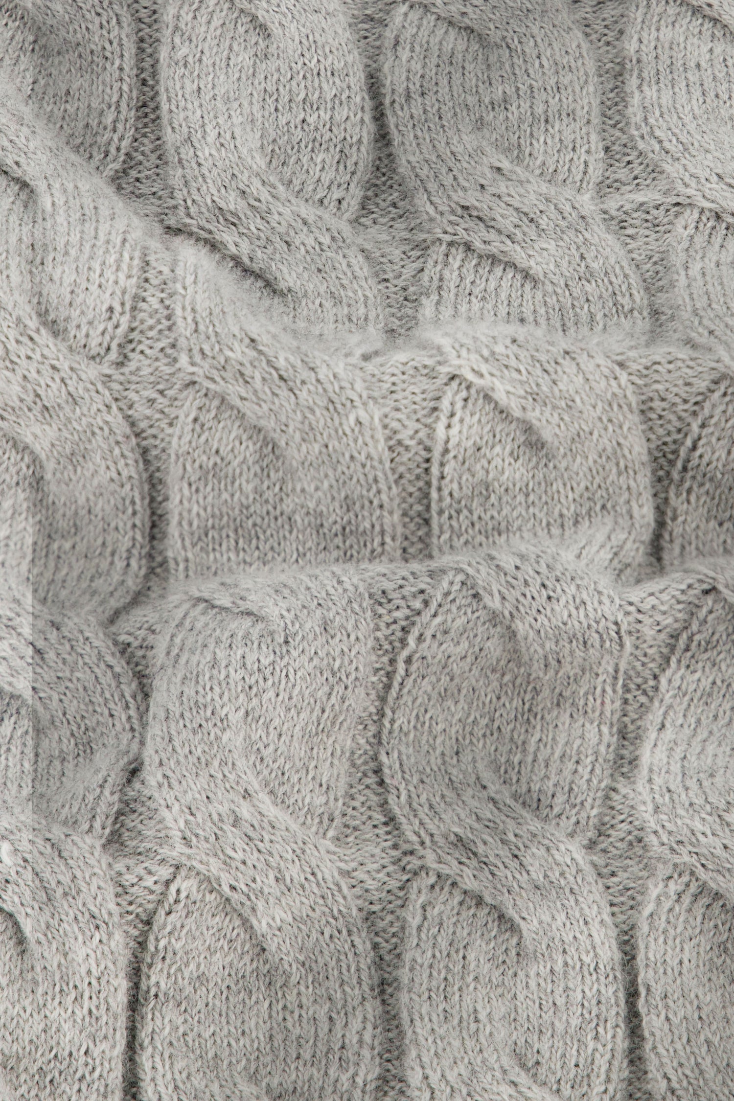 Close-up of the Mini Cables Olivia Pant by Roller Rabbit, featuring soft light gray cotton-cashmere knit with a textured pattern of raised, twisted stitches—ideal for cozy loungewear.