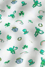 Luck O' the Monkey Polo Pajamas feature a playful St. Patrick’s Day print with green monkeys, shamrocks, leprechaun hats, and rainbows on white—perfect for celebrating in style.