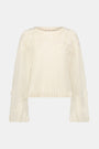 The Crochet Floral Quinn Sweater is a cream, long-sleeve knit with a crew neck and delicate crochet floral accents on the sleeves and chest, made from an alpaca wool blend and shown against a white background.