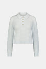 The Wave Knit Ava Sweater features a light blue wavy texture, ribbed hem and cuffs, white collar, and buttoned placket—an elegant addition to any outfit.
