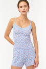 Wearing Roller Rabbit’s Breakfast In Bread Sullivan Shortie pajamas, a person stands against a white background.
