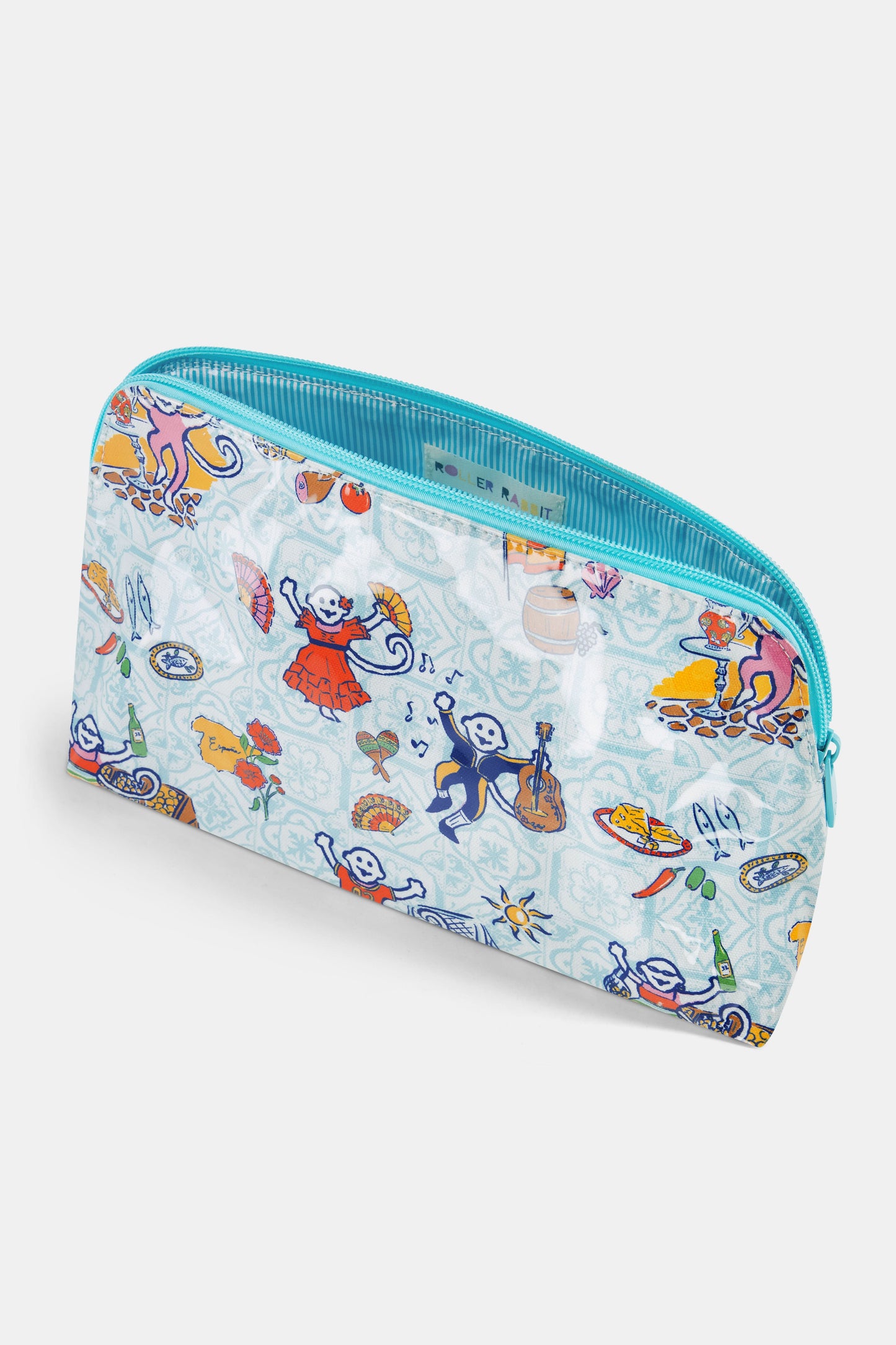 The Spain Monkey Makeup Bag by Roller Rabbit is a colorful cotton canvas pouch featuring playful monkeys in clothes with guitars, fans, fruit, and festive items on a light blue background. Perfect for makeup storage and finished with a blue zipper.