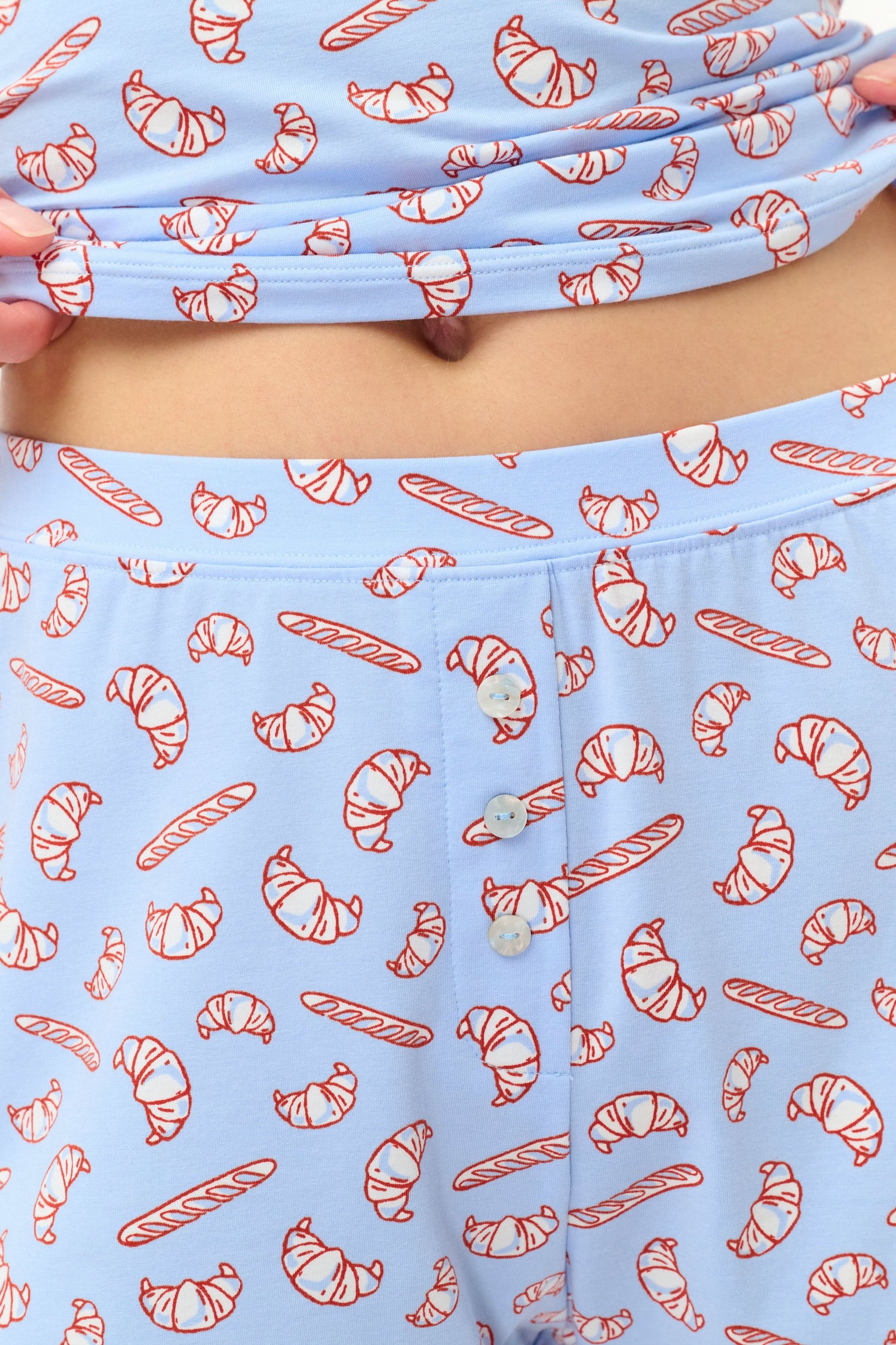 Wearing Roller Rabbit’s Breakfast In Bread Sullivan Shortie pajamas, a person stands against a white background.