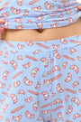 Wearing Roller Rabbit’s Breakfast In Bread Sullivan Shortie pajamas, a person stands against a white background.