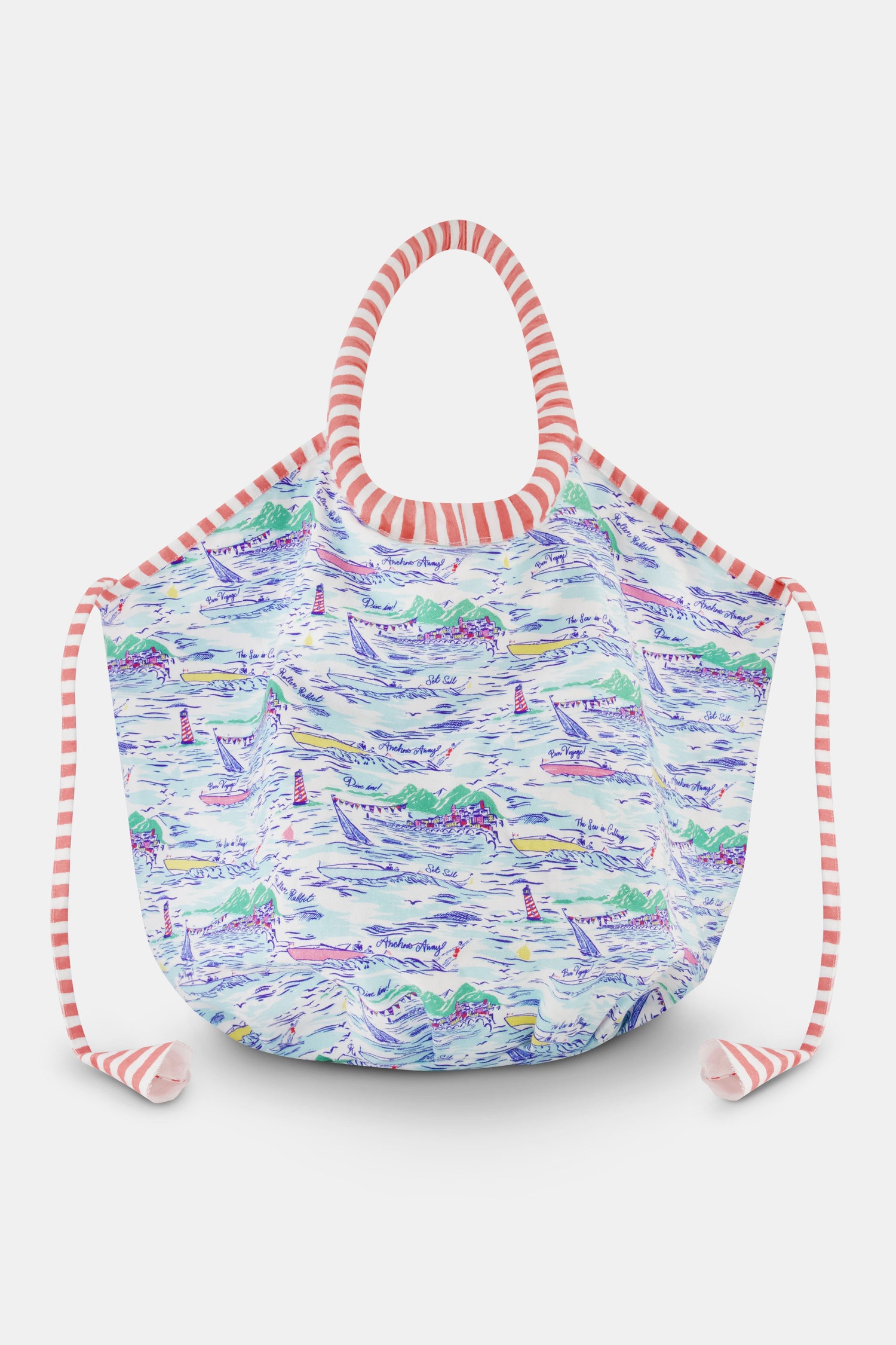 The Regatta Bondi Bag by Roller Rabbit is a large cotton canvas tote with pink and white striped handles, showcasing a vibrant nautical print of boats, lighthouses, and coastal scenery on a white background.