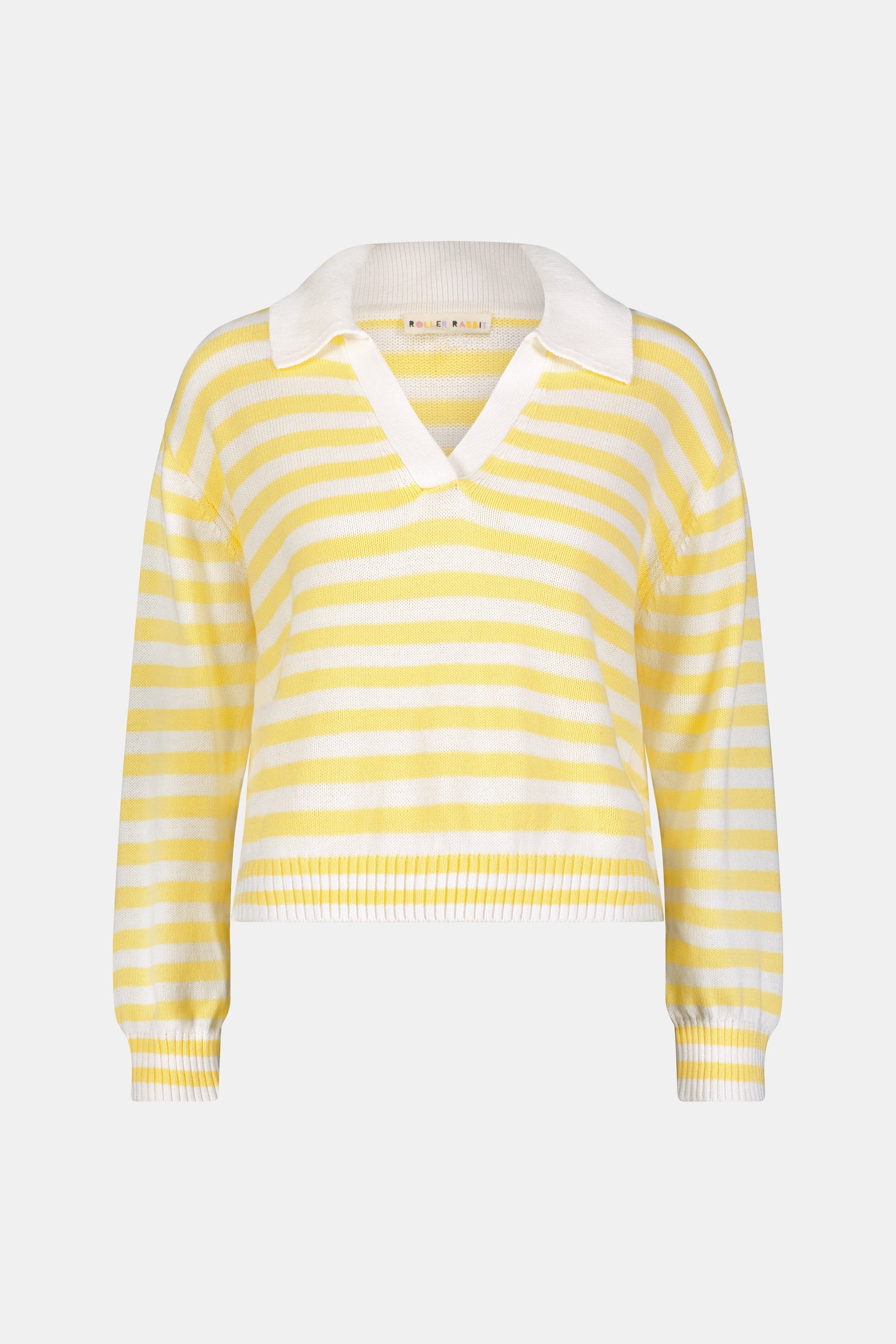 A young woman with light skin and long brown hair wears the Roller Rabbit Striped Rocio Sweater, a pastel yellow, lightweight cotton knit with a wide V-neck and collar. She pairs it with matching drawstring pants and gazes slightly to the side.