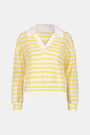 A young woman with light skin and long brown hair wears the Roller Rabbit Striped Rocio Sweater, a pastel yellow, lightweight cotton knit with a wide V-neck and collar. She pairs it with matching drawstring pants and gazes slightly to the side.