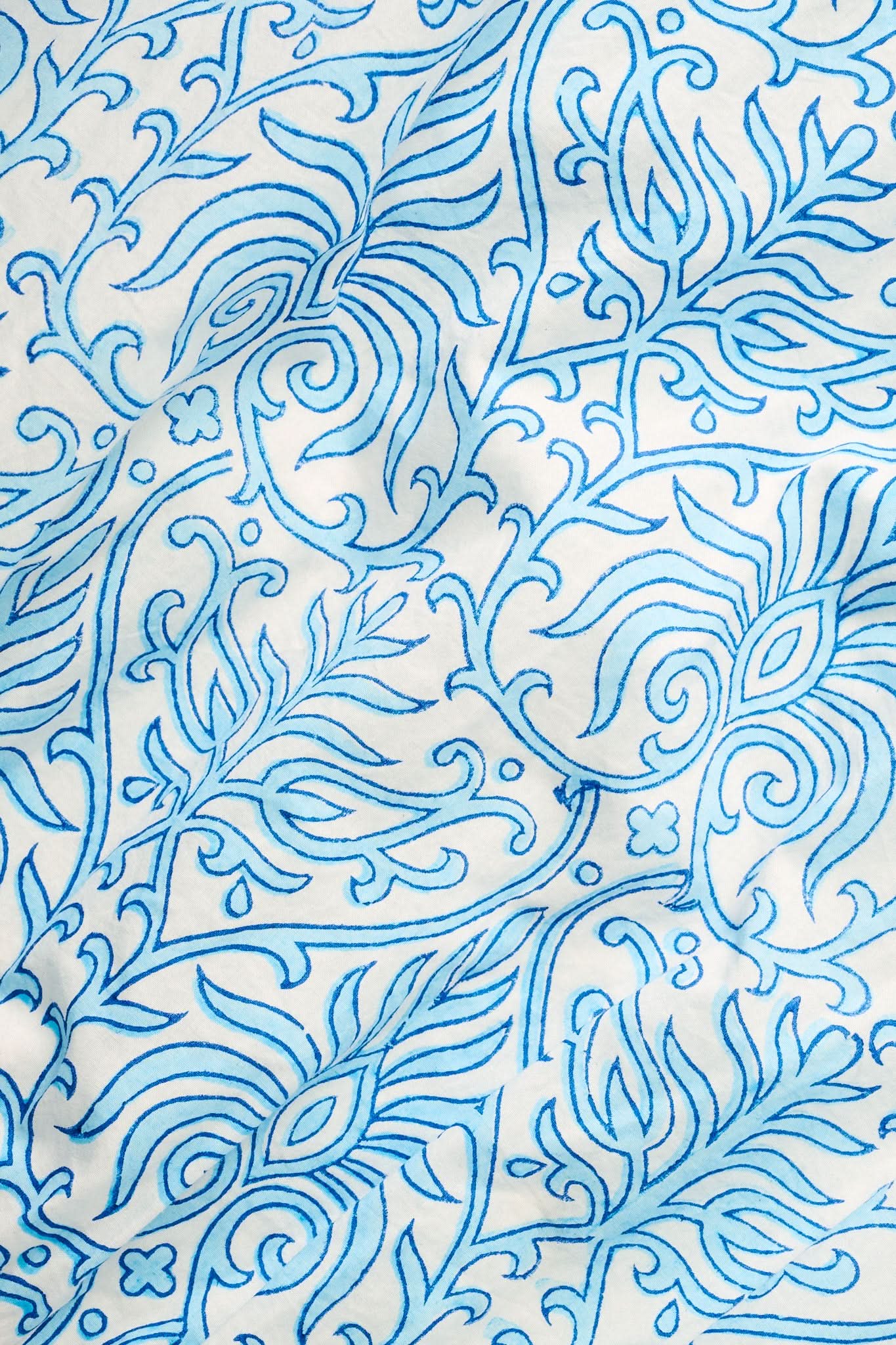 The Roller Rabbit Capi Geo Belted Darla Dress features white fabric with an intricate blue and white print of swirling vines, stylized flowers, and paisley shapes, creating a decorative and elegant look perfect for a maxi or shirtdress style.
