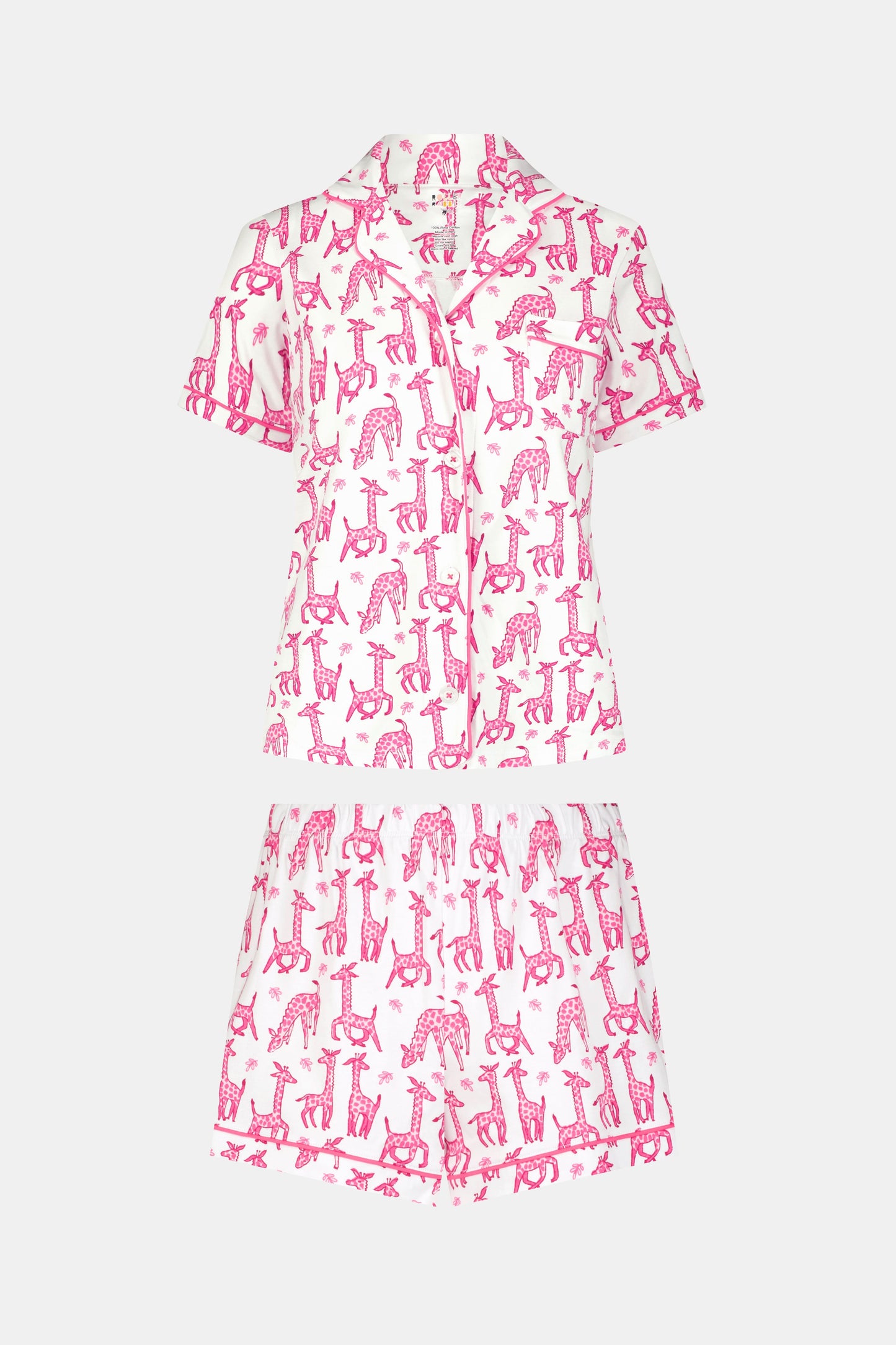The Gigi Giraffe Polo Pajamas feature a short-sleeved, button-up top and matching shorts in soft pima cotton with a white background and playful pink giraffes—perfect for stylish, comfortable lounging.