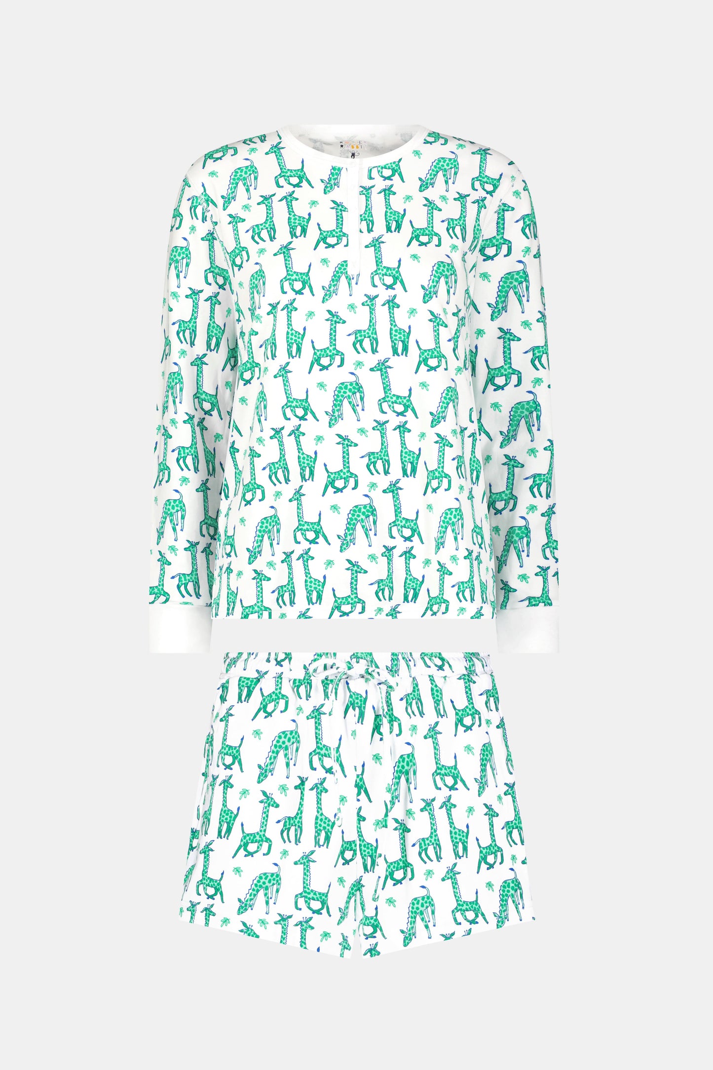 The Gigi Giraffe Hunter Pajamas by Roller Rabbit is a women’s Pima Cotton set with a white base and green-blue giraffe print, featuring a long sleeve top and elastic-waist shorts, shown on a plain light gray background.