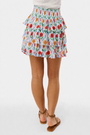 A close-up of the Roller Rabbit Infinity Floral Siggy Skirt, a crinkle chiffon mini with ruffles, featuring red, yellow, pink, and green florals on white. The skirt is styled with a white top.