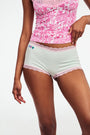 The Roller Rabbit Classic Core Boyshort 4 Pack includes four pairs of girls' underwear in fun patterns—green diamond, white with blue florals, mint with hearts, and light blue floral—all made from soft modal fabric for comfort.