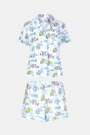 The April Showers Polo Pajamas by Roller Rabbit is a short-sleeved, button-up Pima cotton set with matching shorts, featuring a colorful aquatic animal print in blue, yellow, and purple on white.