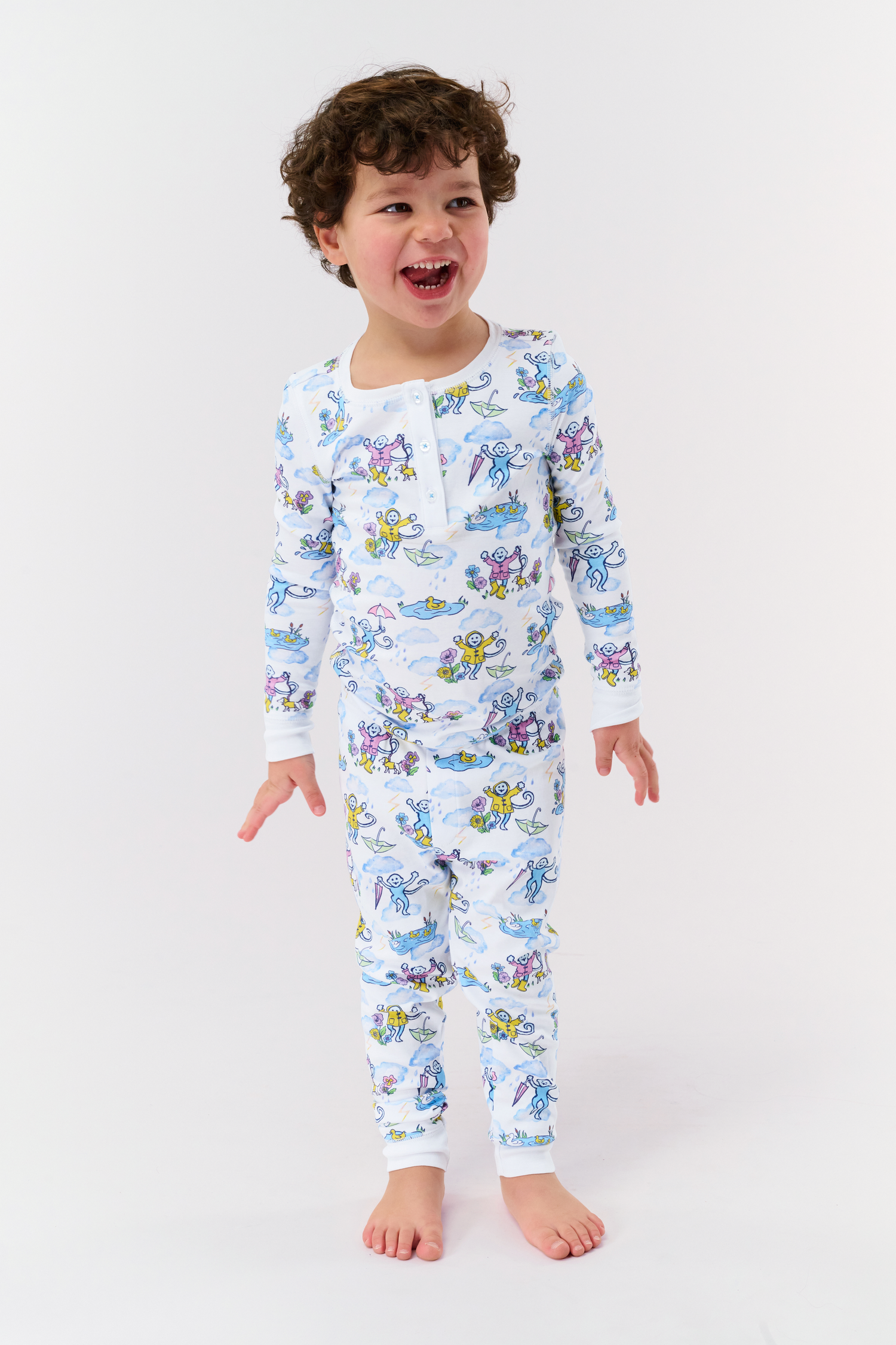Kids April Showers Pajamas set includes a long-sleeve top and pants with colorful underwater-themed cartoon characters and sea creatures on a white background—perfect spring sleepwear for little ones.