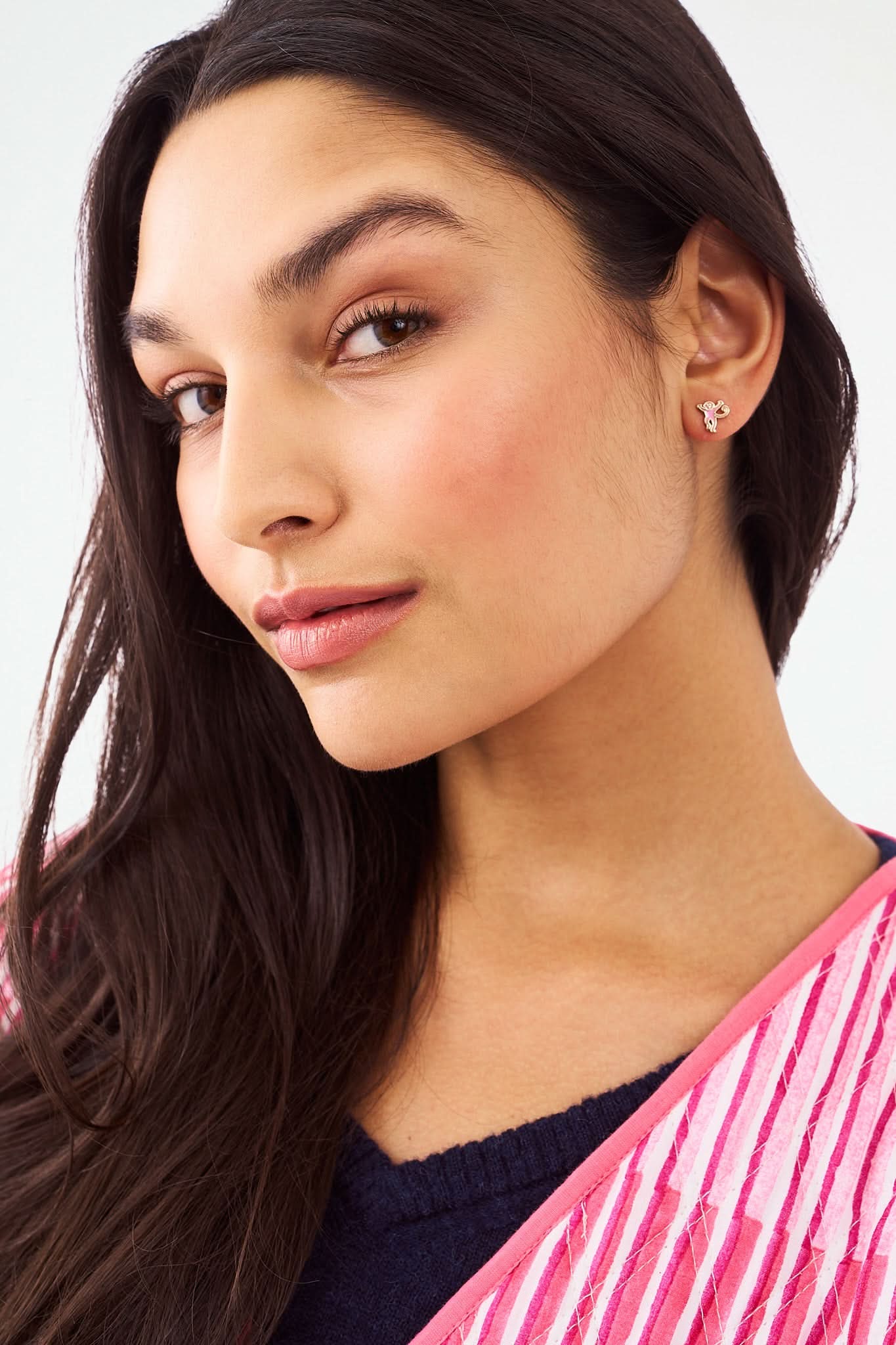 The Icon Party Earring Pack by Roller Rabbit features four pairs of gold and pink icon earrings—whales, hearts, elephants, and unicorns—arranged in two rows on a white background for a fun, playful style.