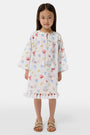 A young child with light brown hair smiles near an open car door, wearing the Roller Rabbit Kids Catch of the Day Serafina Tunic. An adult in matching pajamas is partially visible behind them.