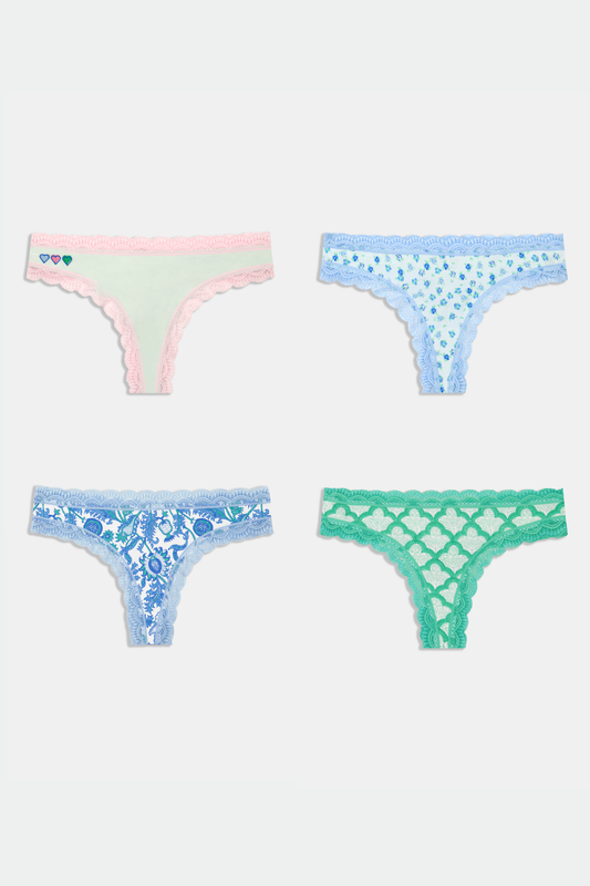 The Roller Rabbit Classic Core Thong 4 Pack features four pairs of lace-trim women’s underwear in pastel shades—pink with hearts, blue with flowers, printed blue, and green—offering soft cotton comfort and cute style.