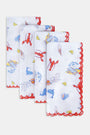 The Catch of the Day Napkin Set Of 4 by Roller Rabbit features white linen napkins with red scalloped edges, showcasing playful sea, beach, and ice cream prints in blue, red, and yellow. The napkins are arranged slightly overlapping.