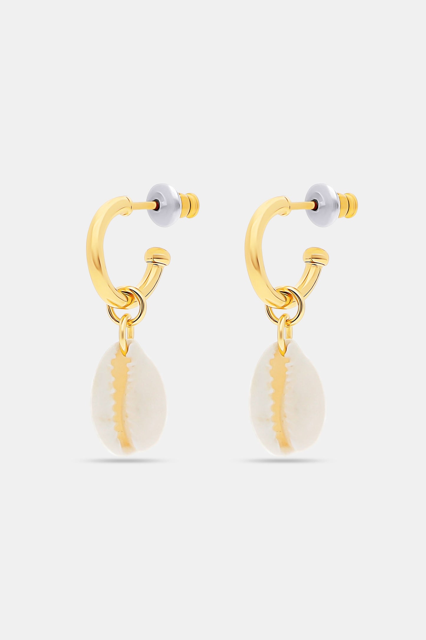 The Marina Earrings Set by Roller Rabbit includes four gold hoops: two with removable oval white shell charms and two with gold fish-shaped charms, all shown on a light gray background.