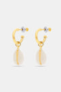 The Marina Earrings Set by Roller Rabbit includes four gold hoops: two with removable oval white shell charms and two with gold fish-shaped charms, all shown on a light gray background.