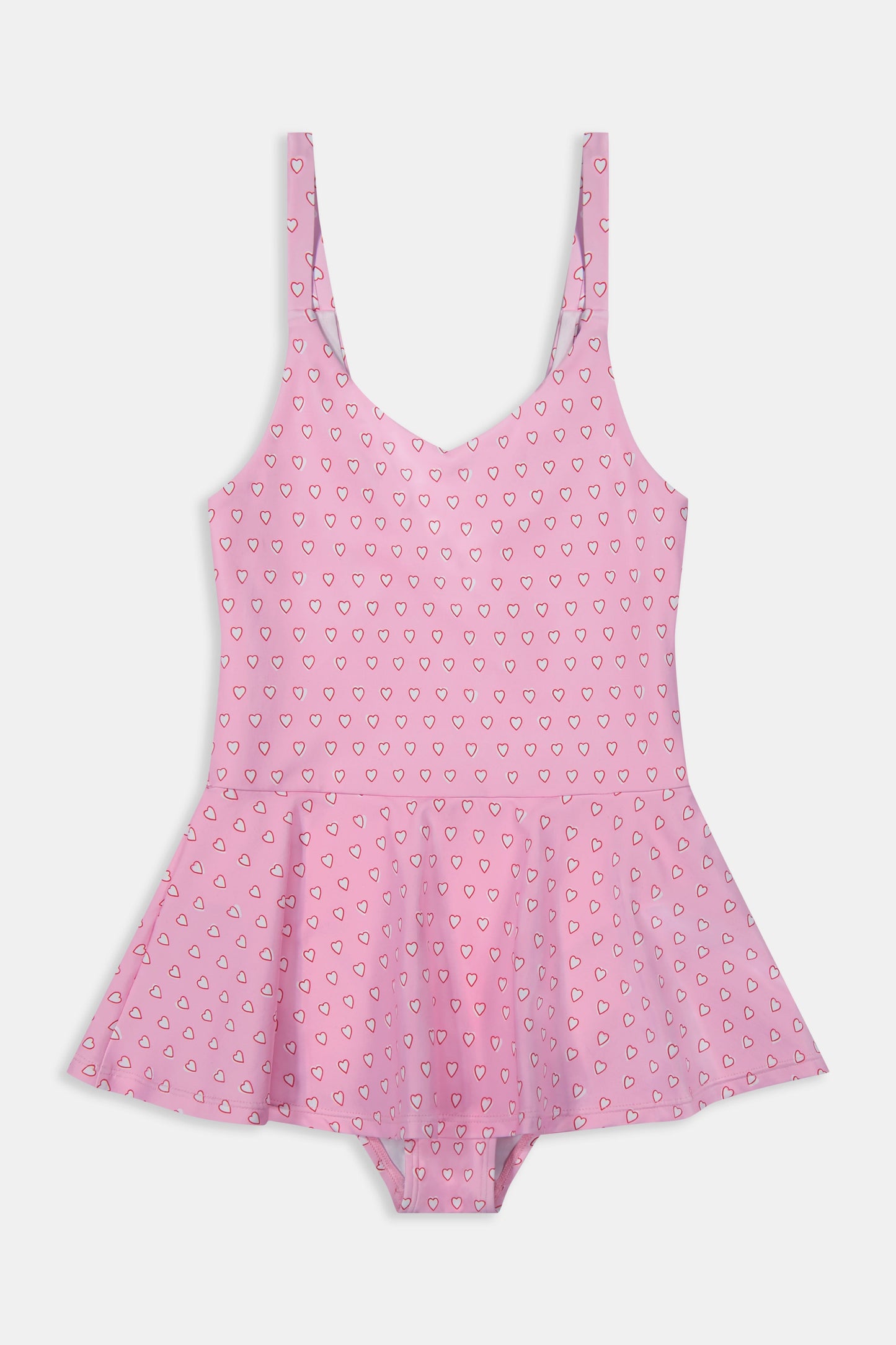 A young girl with long brown hair smiles confidently, wearing the Roller Rabbit Kids Hearts Dory One Piece swimsuit. She stands against a plain light gray background.