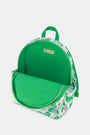 The Roller Rabbit Kids Leo the Lion Backpack is a mini white backpack with a green zipper and handle, decorated with green and purple cartoon lions—including Leo the Lion—and playful floral patterns.