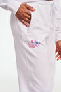 A person stands barefoot in Roller Rabbit O.C. Monkey Sweatpants and a matching hoodie, featuring colorful embroidered and printed graphics near the left pocket. The background is plain white.