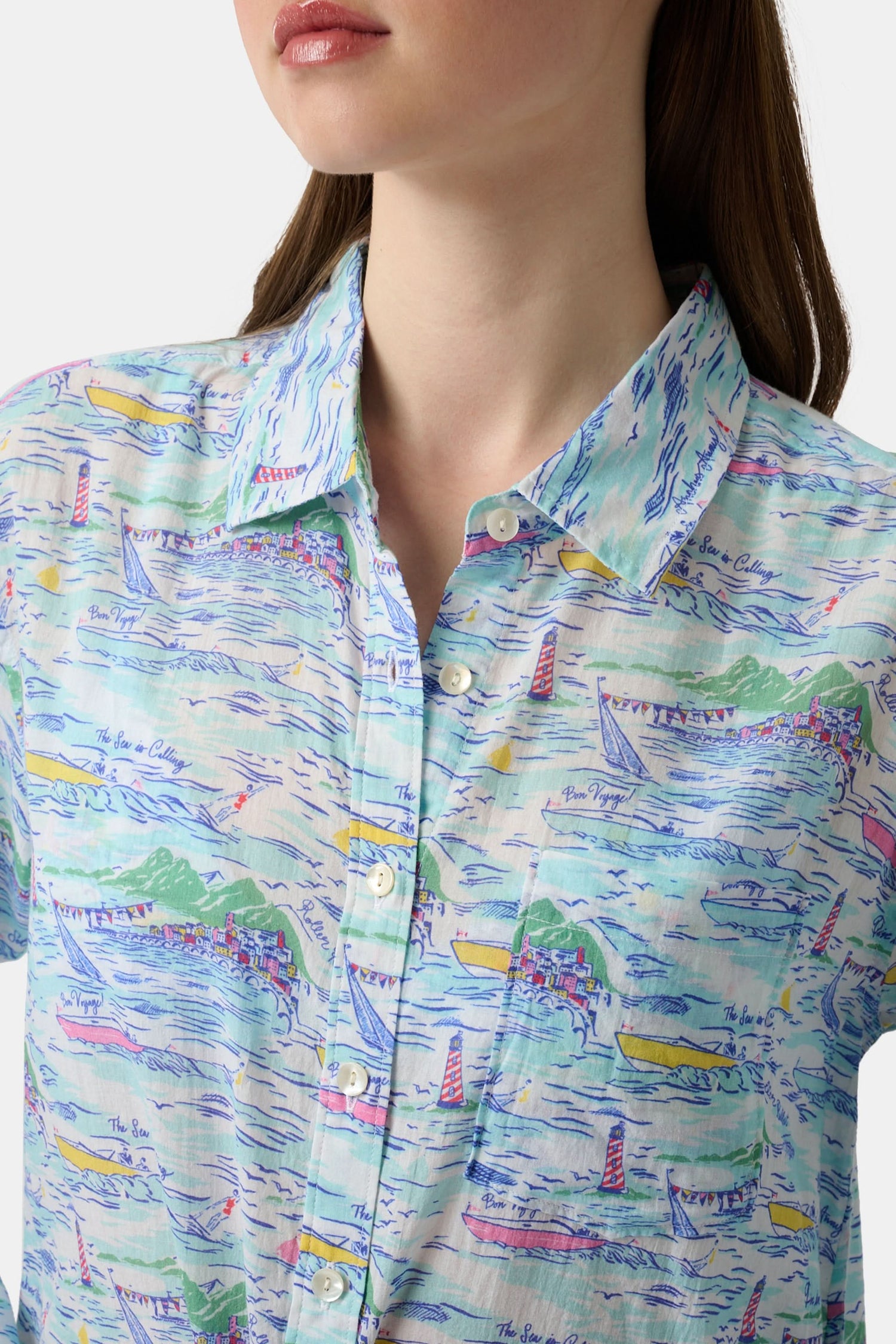 A woman wears the Roller Rabbit Regatta Boyfriend Dress, a loose-fitting cotton voile piece with long sleeves and colorful pastel abstract patterns. The thigh-length dress features a relaxed fit as she stands against a plain, light background.