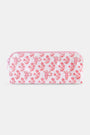 The Roller Rabbit Rosa Ditsy Monkey Makeup Bag is a rectangular pink and white cotton canvas bag with a zippered closure, featuring a red monkey and floral print.