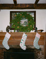 The Roller Rabbit Snow Village Quilted Stocking is a white 100 cotton Christmas stocking featuring festive prints like elves, candy canes, stars, snowmen, gifts, gingerbread house, Christmas trees—perfect for your holiday decor collection.