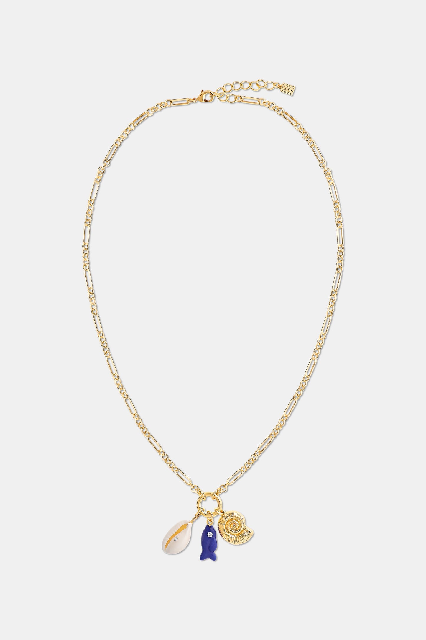 Roller Rabbit's Coastal Charm Necklace features a gold-tone chain with a white shell, blue fish, and gold spiral shell pendant—perfect for summer style—shown on a plain white background.
