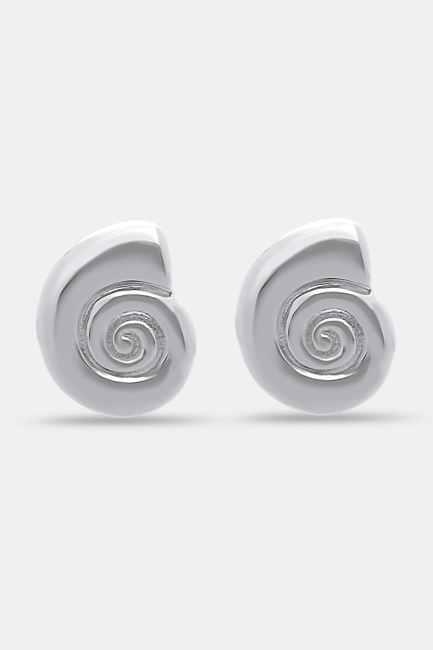 Roller Rabbit Swirl Stud Earrings: shiny silver studs shaped like abstract shells with a raised spiral design in the center, shown on a plain light gray background.