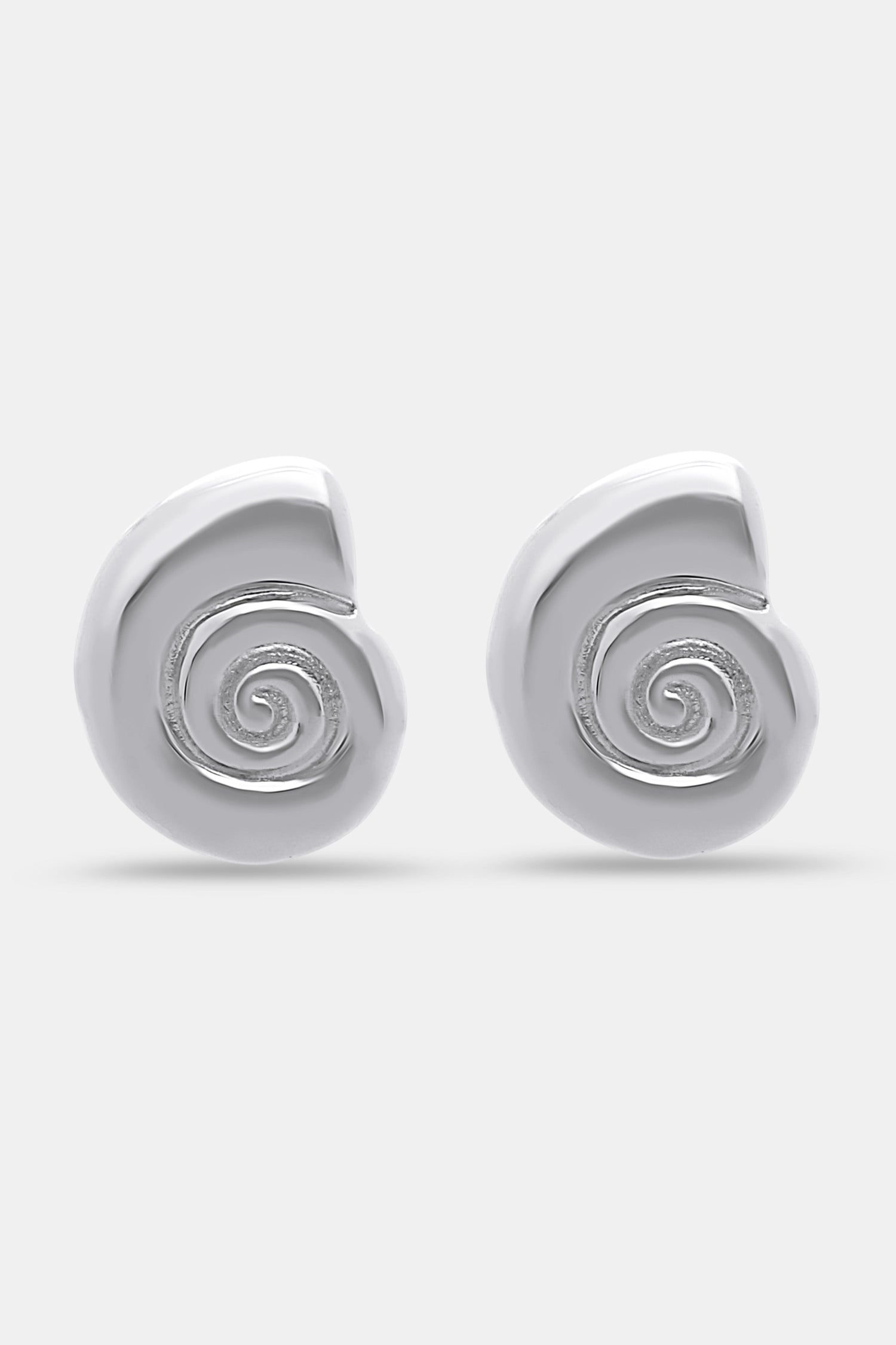 Roller Rabbit Swirl Stud Earrings: shiny silver studs shaped like abstract shells with a raised spiral design in the center, shown on a plain light gray background.
