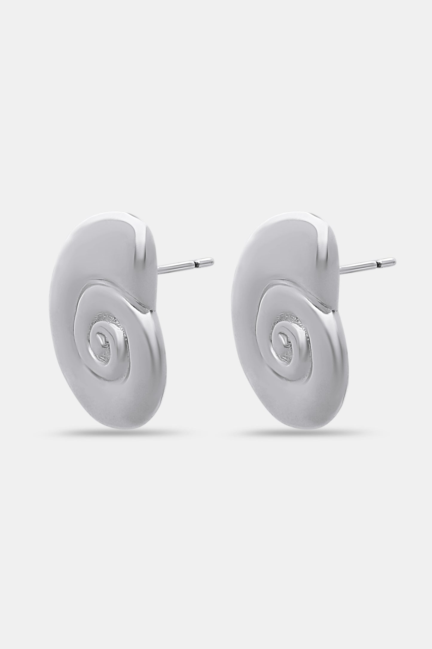 Roller Rabbit Swirl Stud Earrings: shiny silver studs shaped like abstract shells with a raised spiral design in the center, shown on a plain light gray background.