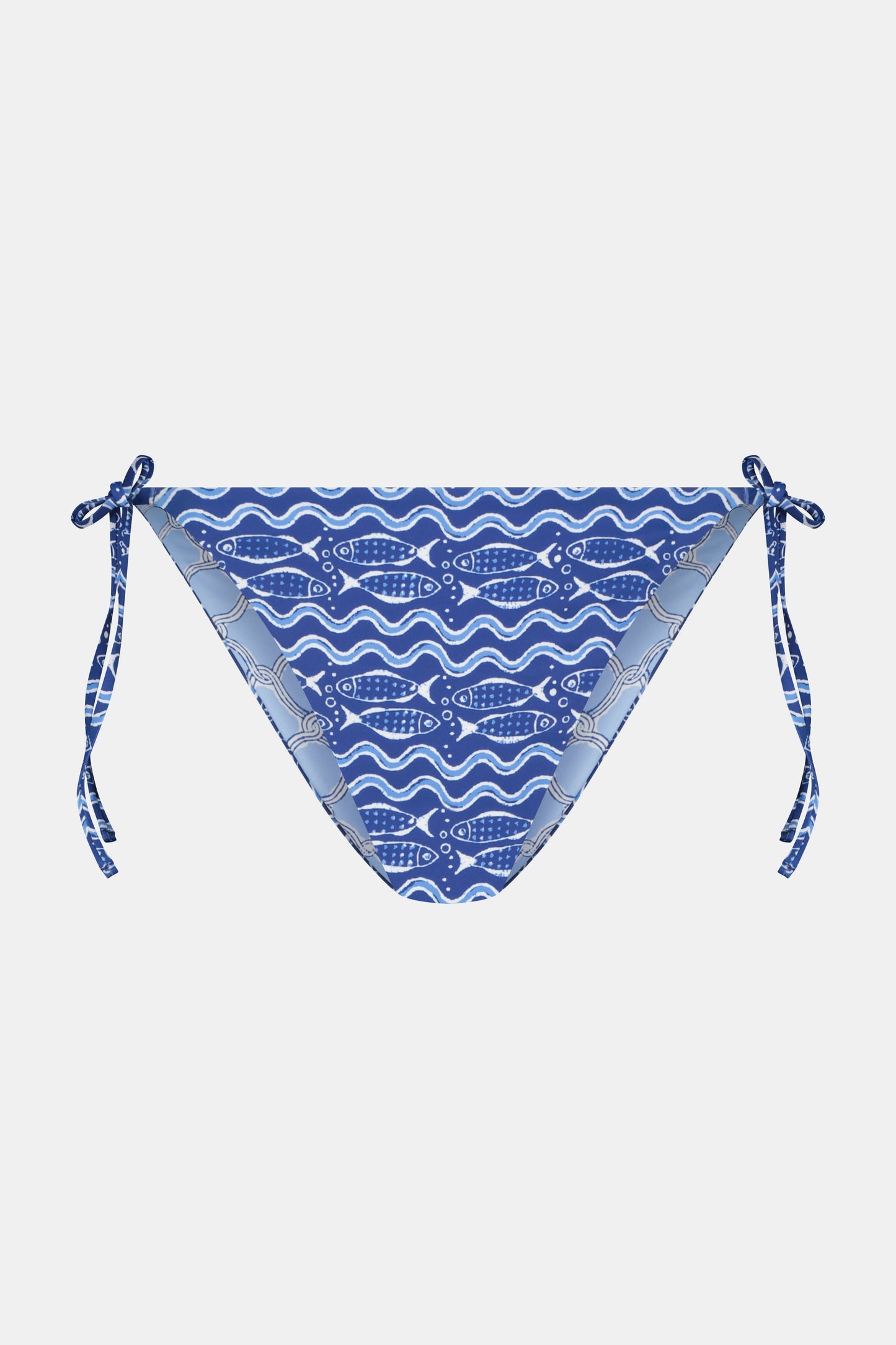 A person wears the Roller Rabbit Fish Stripe/Ruban Serena Bikini Bottom in blue with side ties, shown from torso to upper thighs against a plain white background. This bikini bottom offers UPF 50+ sun protection.