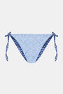A person wears the Roller Rabbit Fish Stripe/Ruban Serena Bikini Bottom in blue with side ties, shown from torso to upper thighs against a plain white background. This bikini bottom offers UPF 50+ sun protection.