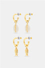 The Marina Earrings Set by Roller Rabbit includes four gold hoops: two with removable oval white shell charms and two with gold fish-shaped charms, all shown on a light gray background.